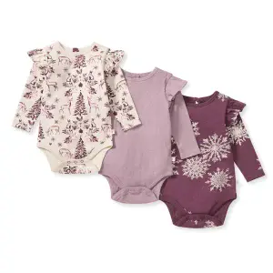 Burt’s Bees Baby 3-pack Snowflakes and Woodland Story baby girl bodysuits featuring deer, pine trees, and snowflake prints with long sleeves and flutter details