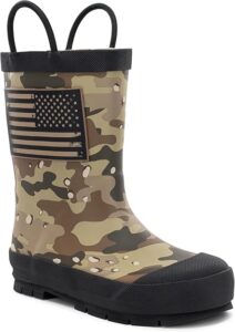 Toddler wearing waterproof rain boots with pull-on handles, standing in puddles during outdoor play