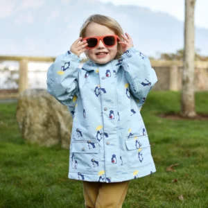 Jan & Jul Penguin Party fleece-lined rain jacket for kids with a colorful penguin print, hood, and waterproof outer layer