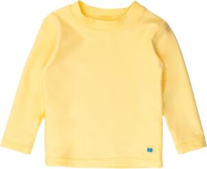 Toddler boy wearing a bright banana yellow long sleeve RUGGEDBUTTS rash guard swim shirt with UPF 50+ sun protection for beach and pool days